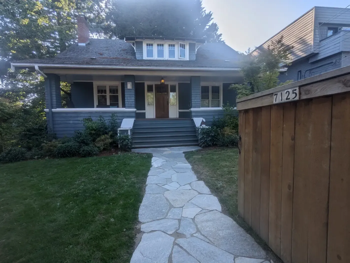 Flagstone front walk through lawn up to bungalow entry steps