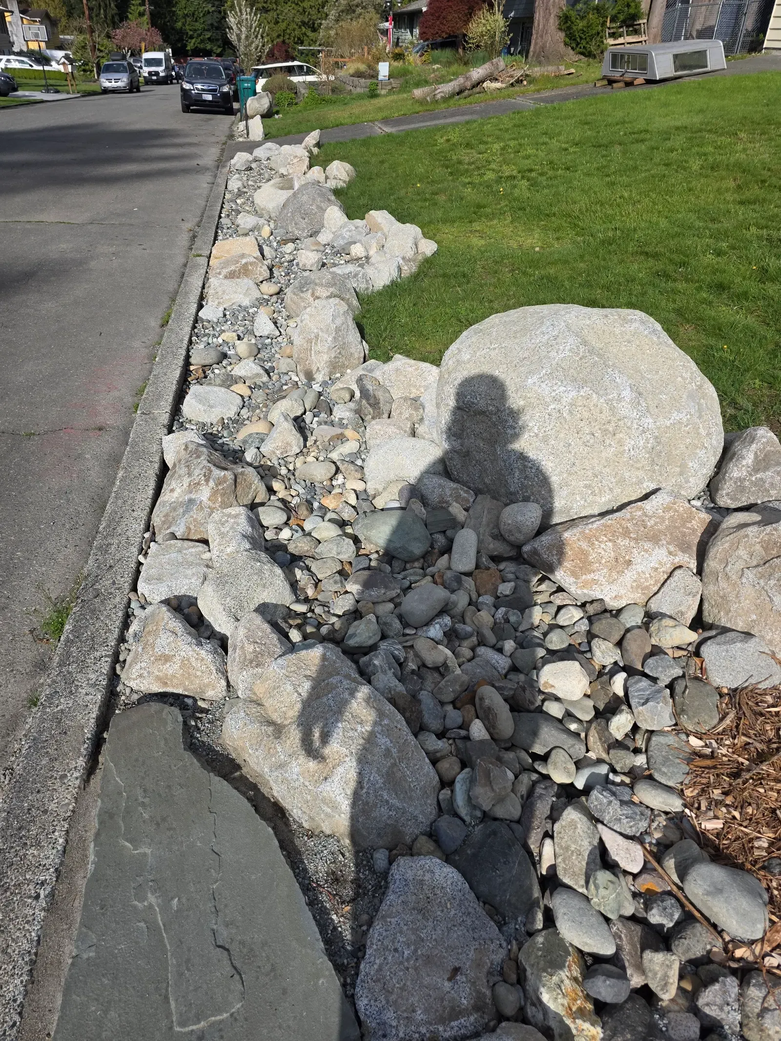 Graduated river rock channel set between stone edging along the path