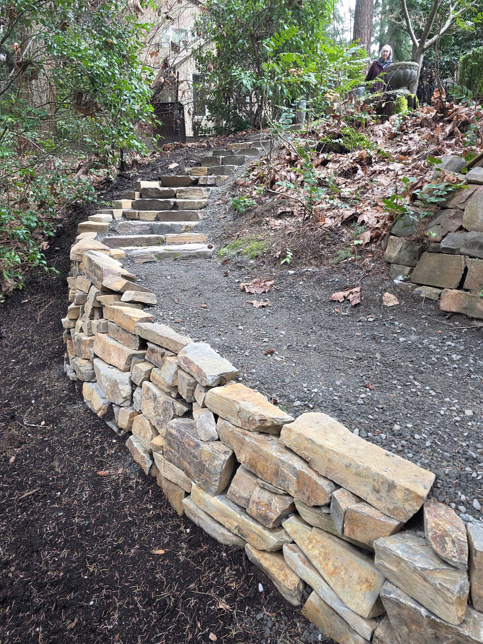 Drystack Ledgestone Wall and Stone Steps Into a Forested Yard